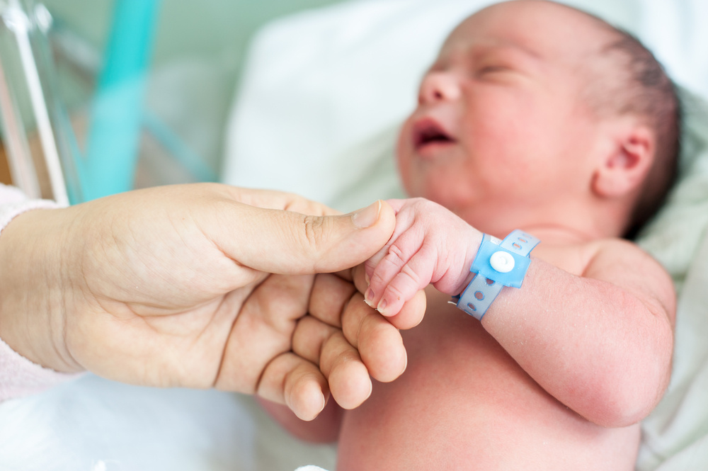 Newborn baby in hospital with identification bracelet tag name Newborn baby in hospital with identification bracelet tag name